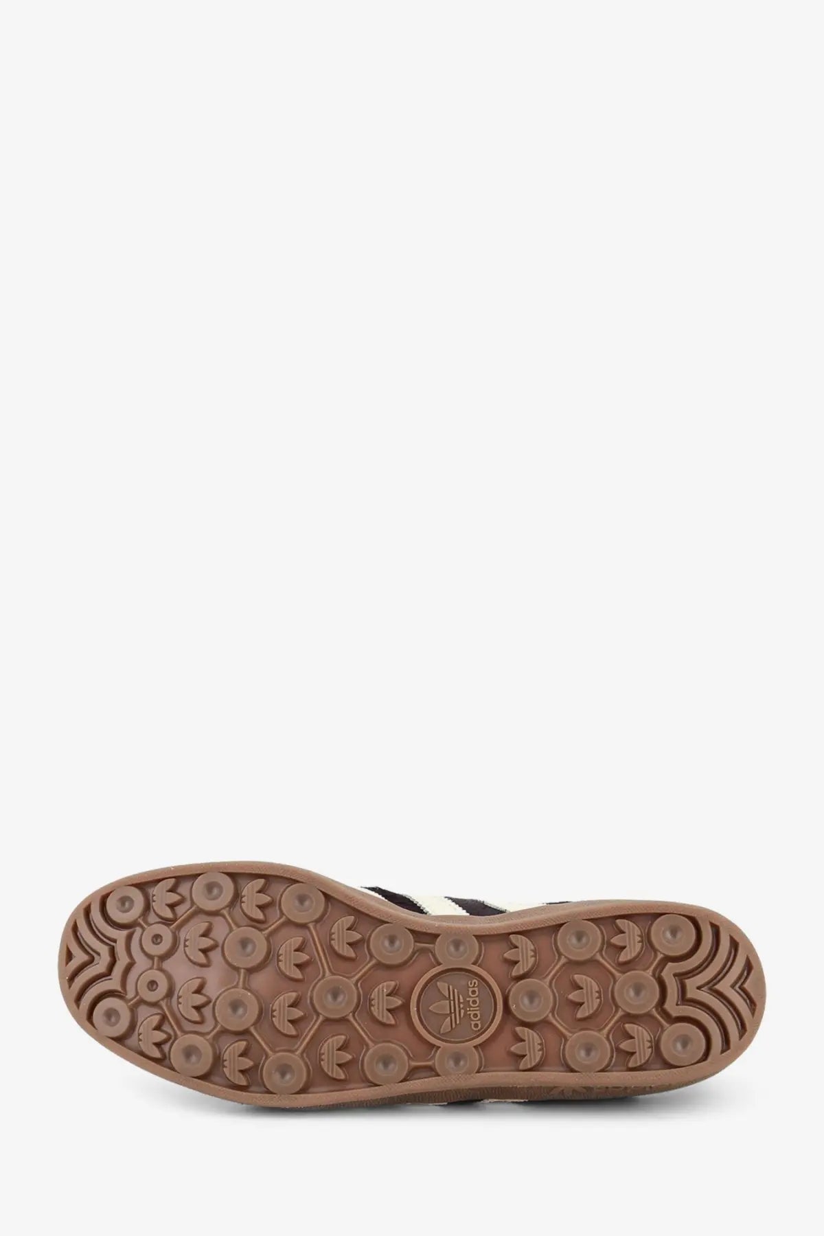 Brown rubber sole with embossed adidas logo and three-stripe pattern on adidas originals by wales bonner wb gazelle sneakers