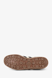 Brown rubber sole with embossed adidas logo and three-stripe pattern on adidas originals by wales bonner wb gazelle sneakers