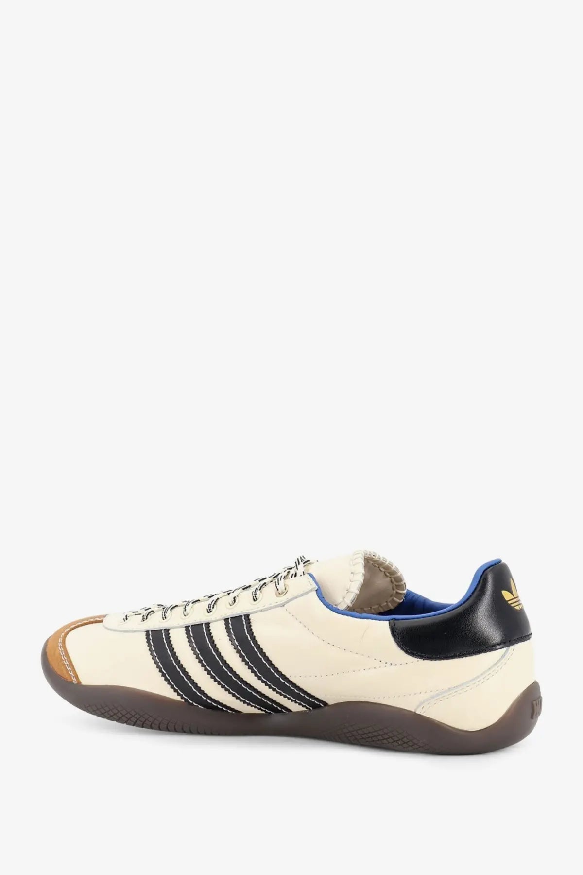Cream-colored adidas Originals by Wales Bonner unisex WB Karintha OG leather sneaker with black stripes navy heel tab and gold logo
