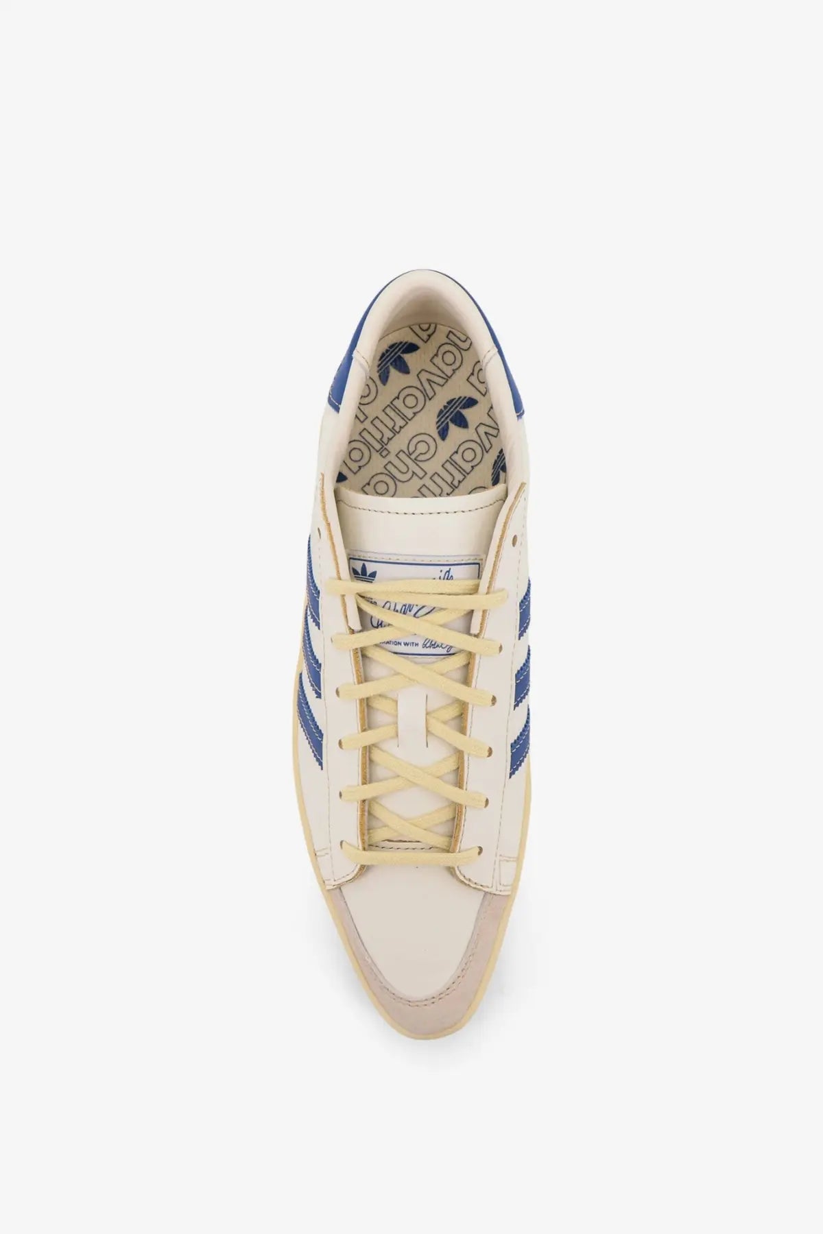 Cream-colored adidas originals x willy chavarria men’s chavarria jabbar dress sneakers with blue stripes and laces