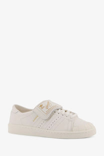 White adidas originals x willy chavarria low top leather sneaker with gold branding and velcro strap