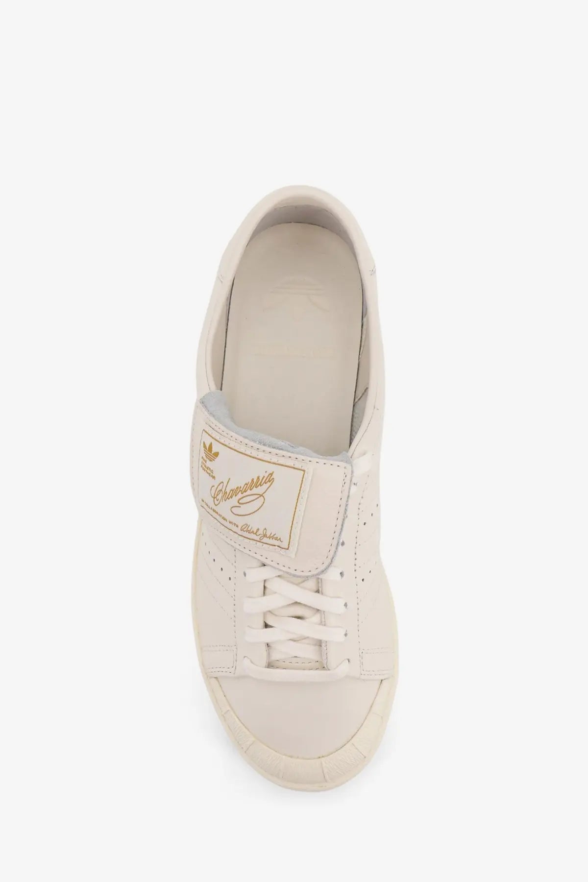 Cream-colored leather adidas stan smith sneaker with gold branding and classic lace-up design for men