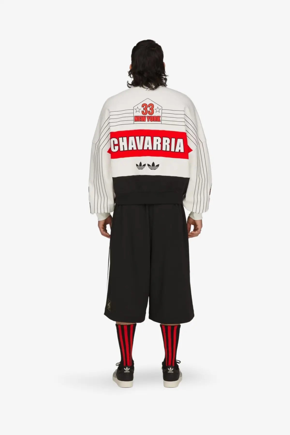 Back of a white and black striped adidas Originals x Willy Chavarria cotton bomber jacket with red vintage sports graphic