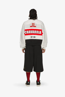 Back of a white and black striped adidas Originals x Willy Chavarria cotton bomber jacket with red vintage sports graphic
