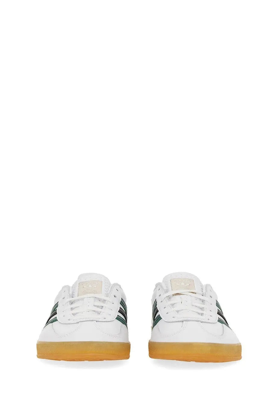 White adidas unisex gazelle indoor shoe with dark green stripes and gum-colored rubber sole