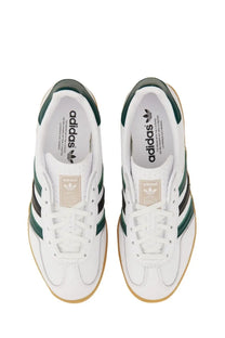 White adidas unisex gazelle indoor shoe with green stripes tan heel tab and classic leather construction