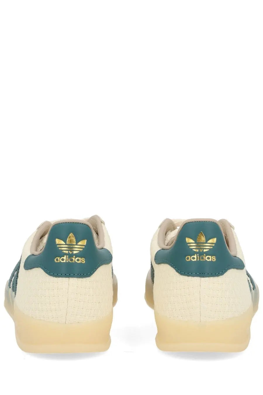Back view of cream-colored adidas unisex gazelle indoor sneaker with teal accents and gold branding on the heel