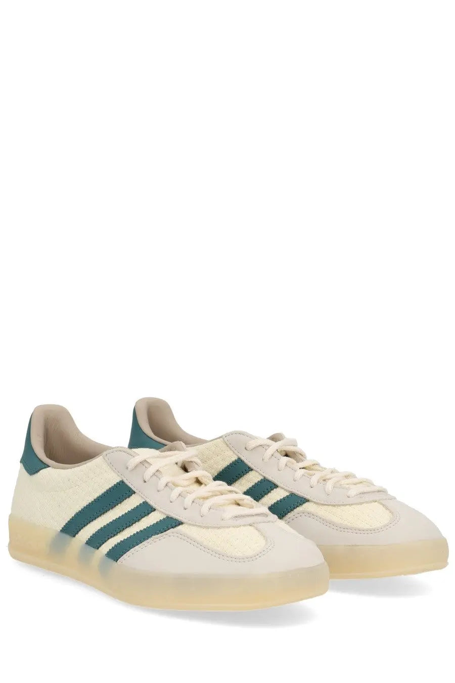 Cream-colored adidas unisex gazelle indoor sneaker with teal stripes and translucent gum sole in beige