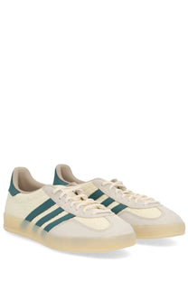 Cream-colored adidas unisex gazelle indoor sneaker with teal stripes and translucent gum sole in beige