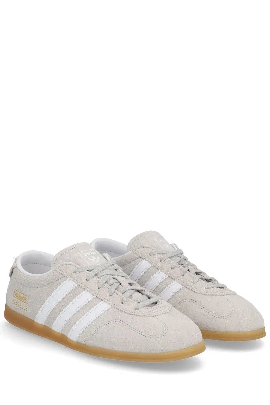 Beige suede adidas unisex gazelle lo pro sneaker with white stripes and gum rubber sole gray color