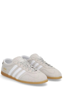 Beige suede adidas unisex gazelle lo pro sneaker with white stripes and gum rubber sole gray color