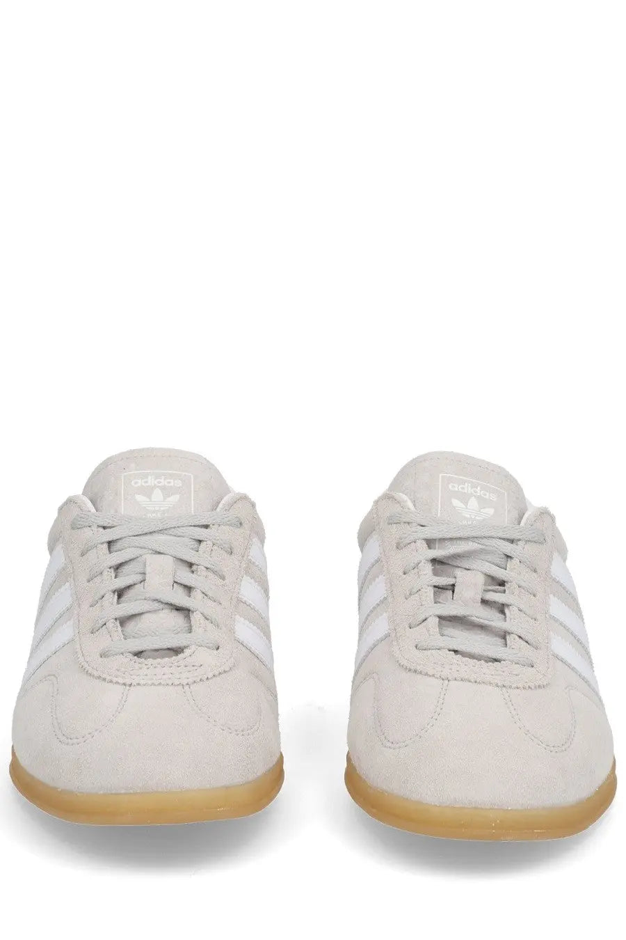 Light gray suede adidas unisex gazelle lo pro sneaker with white stripes and gum rubber sole