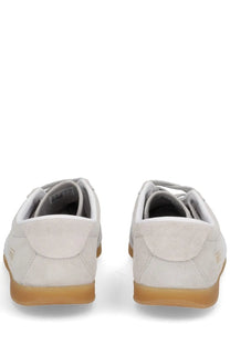 Adidas unisex Gazelle LO Pro sneaker in light gray suede with tan rubber sole and subtle heel branding