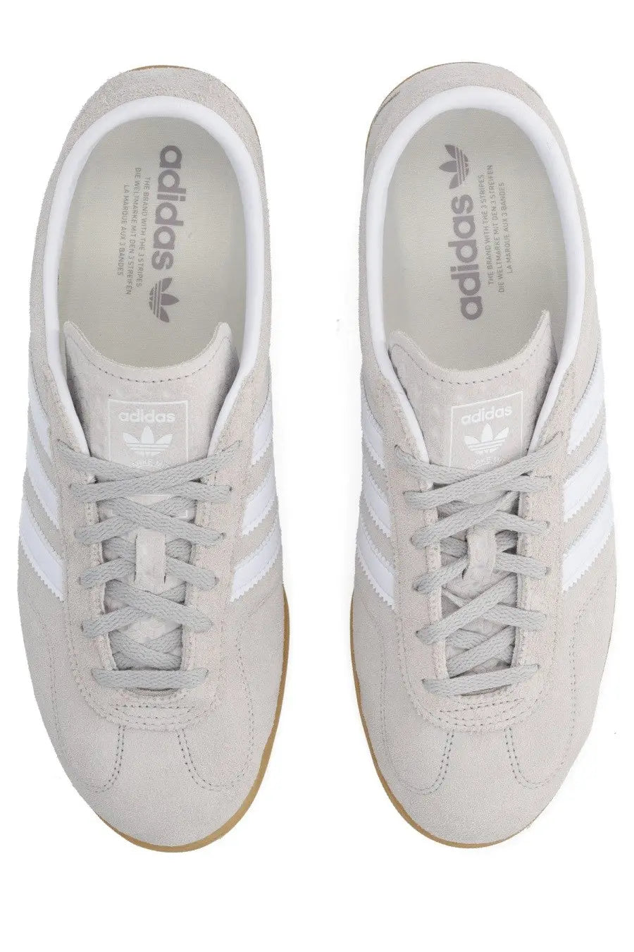 Light gray suede adidas unisex Gazelle LO Pro sneaker with white three-stripe detailing and gum-colored rubber sole