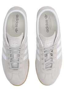 Light gray suede adidas unisex Gazelle LO Pro sneaker with white three-stripe detailing and gum-colored rubber sole