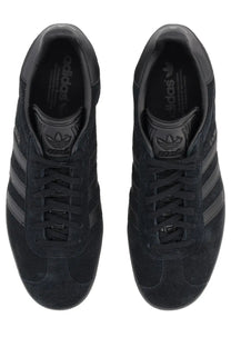 Black suede adidas unisex gazelle sneaker with three-tone black stripes and matching laces