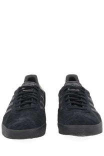 Adidas unisex Gazelle sneaker in black suede with three-tone black stripes and matching laces