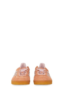 Peach-colored suede adidas gazelle unisex indoor sneaker with white stripes and translucent gum sole