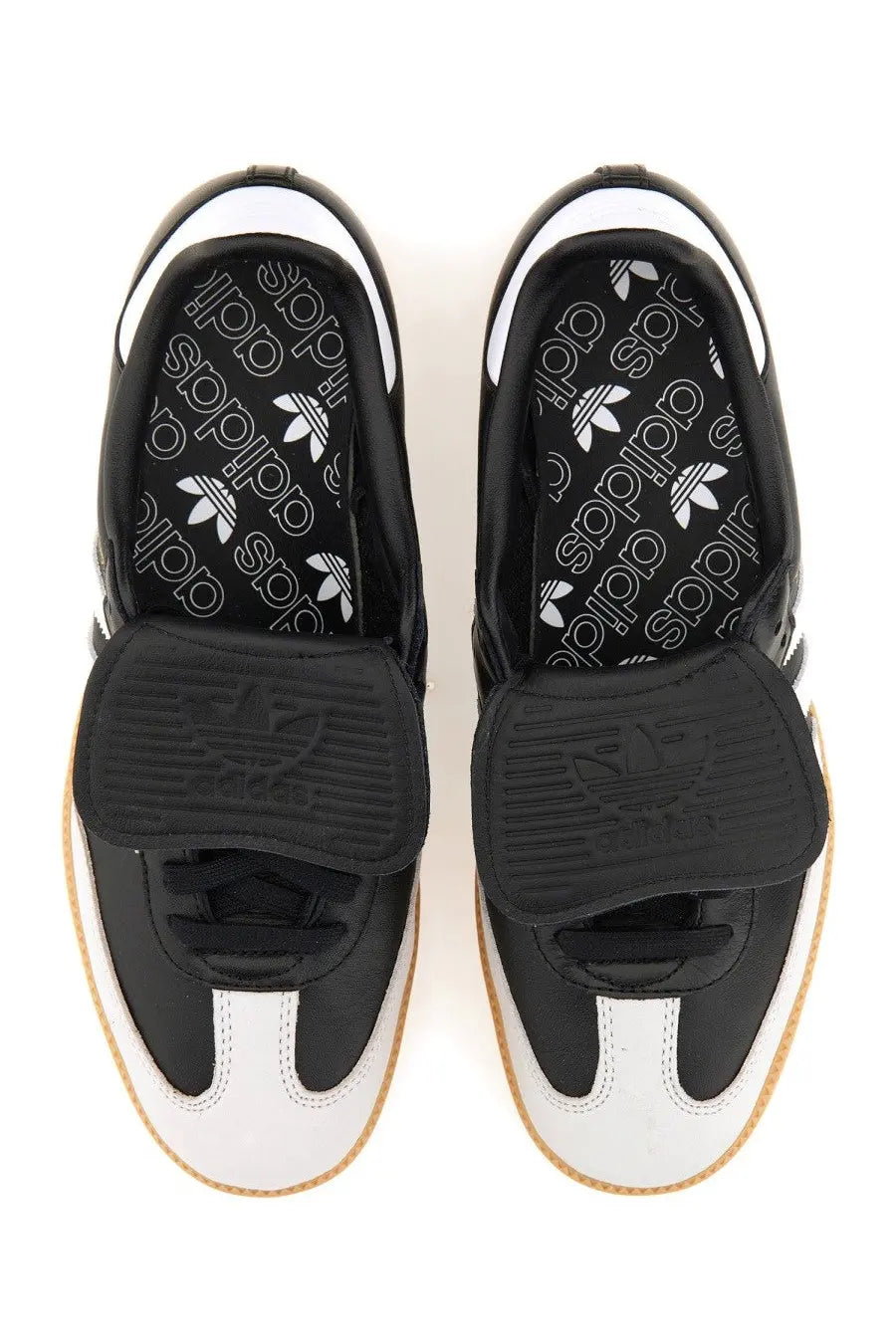 Black and white adidas unisex samba lt sneaker with velcro strap rubber sole and trefoil logo on insole