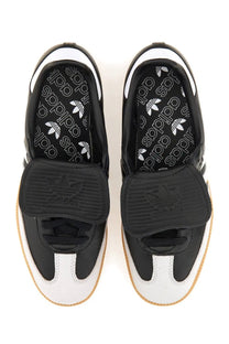 Black and white adidas unisex samba lt sneaker with velcro strap rubber sole and trefoil logo on insole