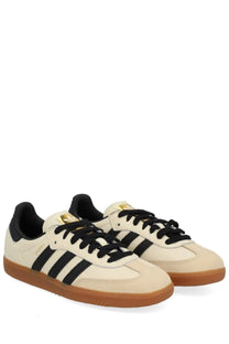 Cream-colored adidas unisex samba og sneakers with black three stripes black laces and gum rubber sole
