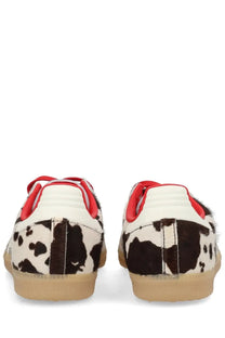Adidas unisex Samba OG sneaker with black and white cow print suede red accents and tan rubber sole