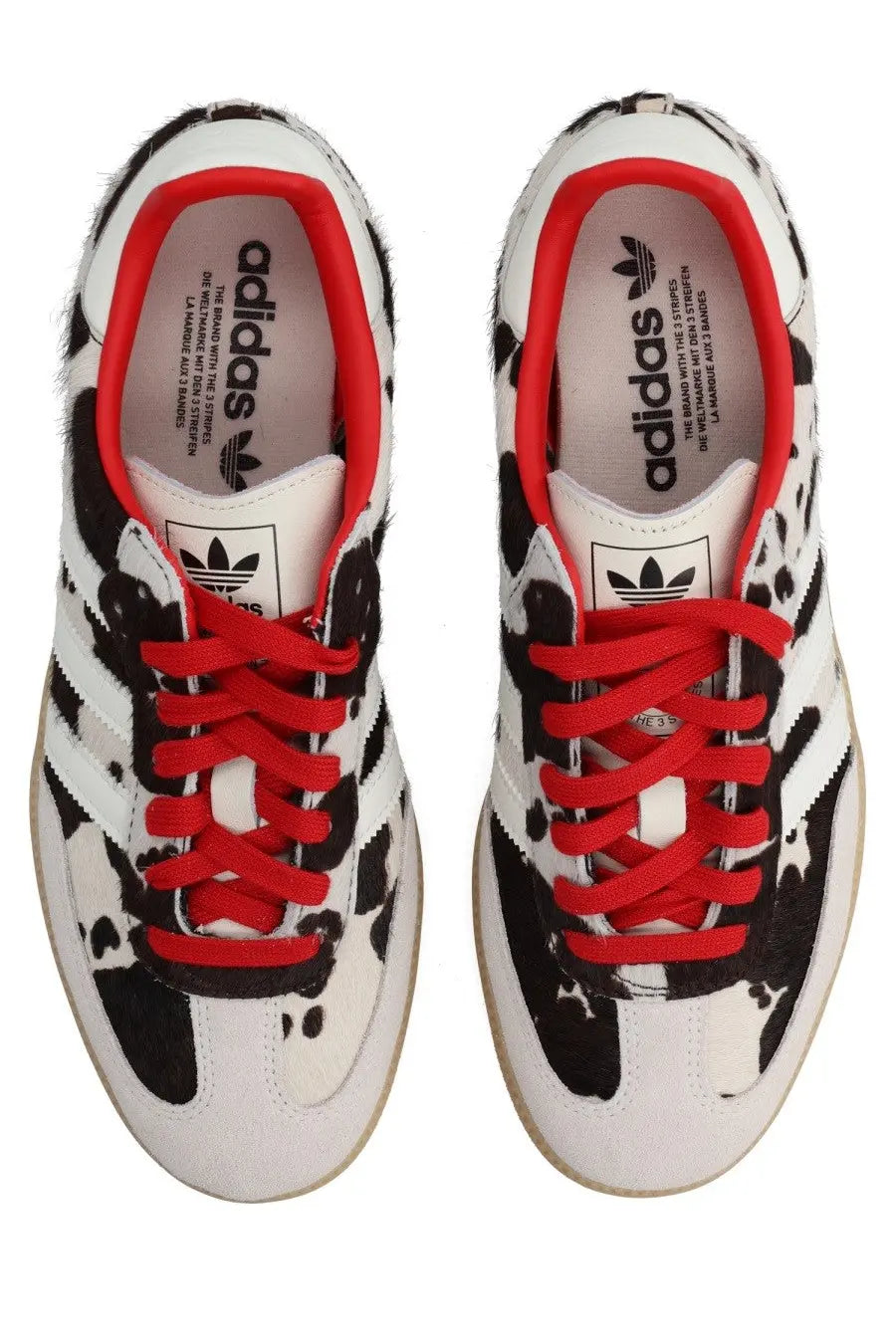 White adidas unisex samba OG sneaker with black splatter paint design vibrant red laces and iconic three stripes