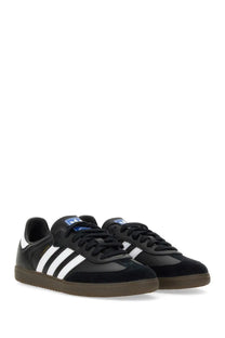 Black adidas unisex samba sneaker with white three stripes and brown rubber sole designed for casual wear