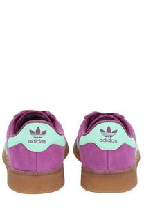 Purple suede adidas unisex sneaker muenchen with mint green heel tabs and gum rubber soles shown from the back