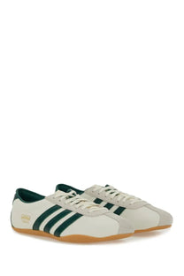 Cream-colored adidas unisex sneaker tokyo white with dark green stripes and tan rubber sole
