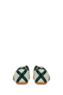 Adidas unisex sneaker tokyo white with white upper dark green cross straps and tan rubber soles visible from the front
