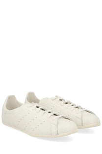 Cream-colored leather adidas unisex Stan Smith LO Pro sneaker with perforated detailing and classic low-top design