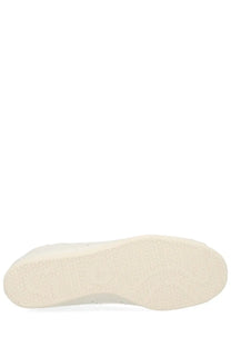 White rubber textured sole of adidas unisex stan smith lo pro sneaker in white showing patterned surface