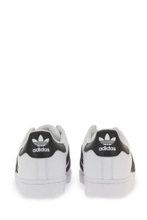 White adidas unisex superstar sneaker showing back side with black leather accents and trefoil logo on heel