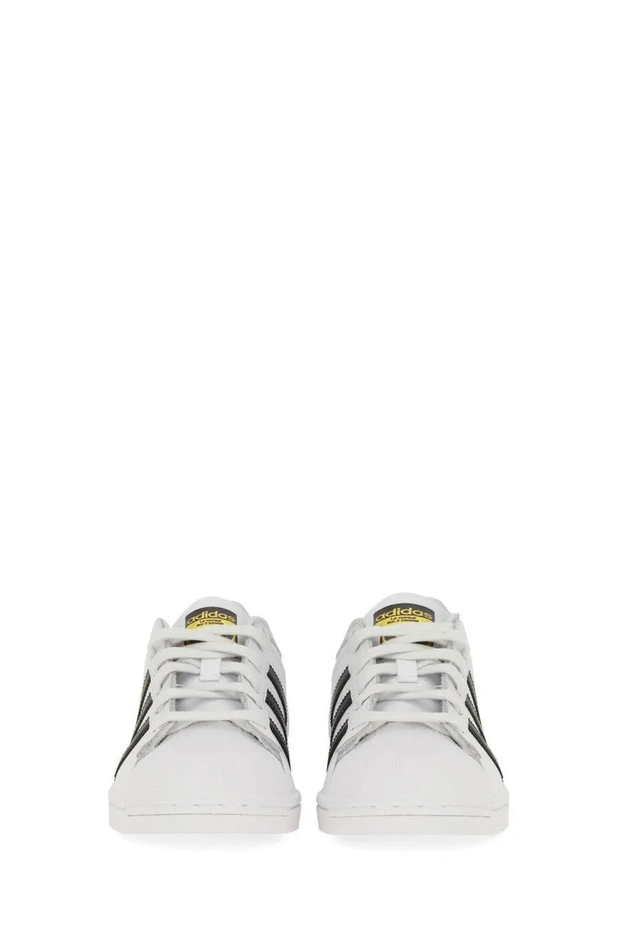 White adidas unisex superstar sneakers with black three stripes and gold branding on the tongue