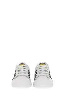 White adidas unisex superstar sneakers with black three stripes and gold branding on the tongue