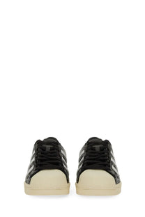 Adidas unisex superstar vintage sneaker black with glossy patent leather uppers and cream rubber toe caps