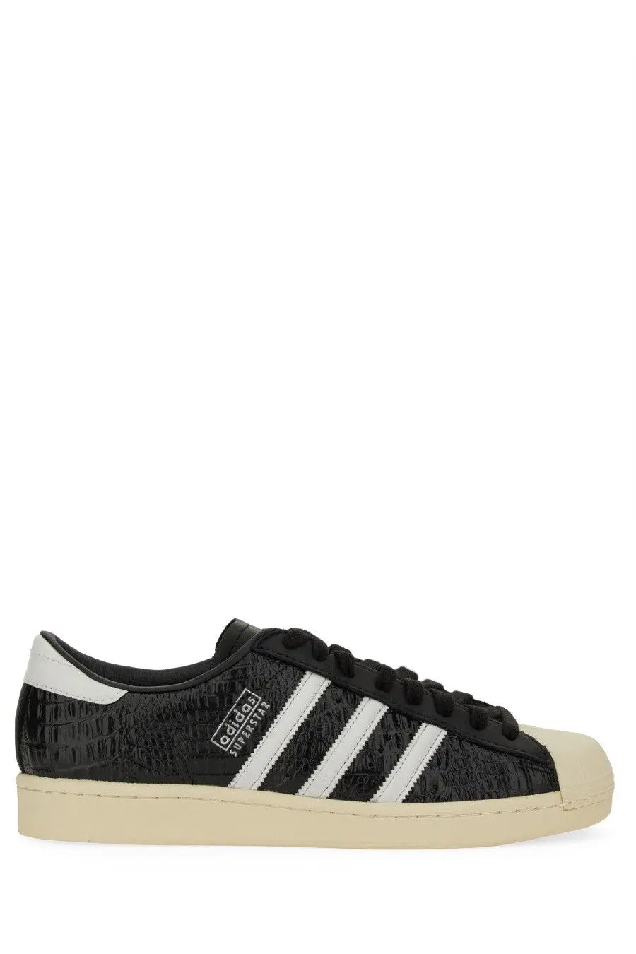 Black adidas unisex superstar vintage sneaker with textured crocodile-embossed upper white three stripes and rubber toe cap
