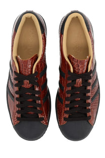 Burgundy croc-embossed leather adidas unisex superstar vintage sneakers with black rubber toe caps and three stripes