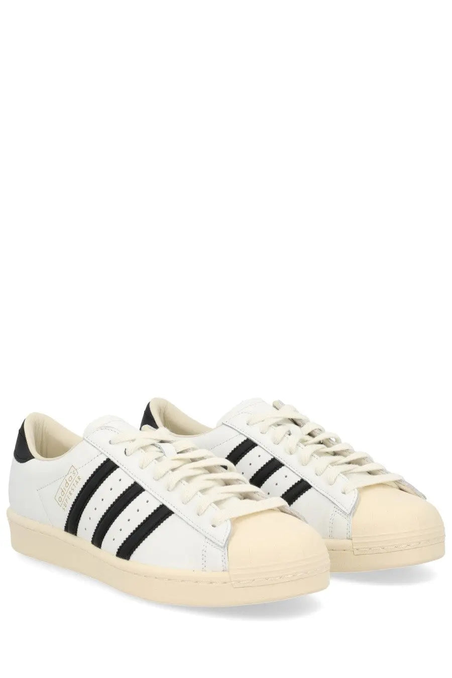 Adidas unisex Superstar vintage sneaker white leather with black three stripes and cream rubber toe cap