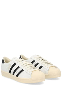 Adidas unisex Superstar vintage sneaker white leather with black three stripes and cream rubber toe cap