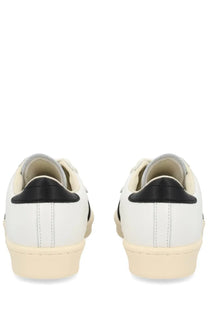 Adidas unisex superstar vintage sneaker white with white leather upper black heel tabs and cream-colored soles back view