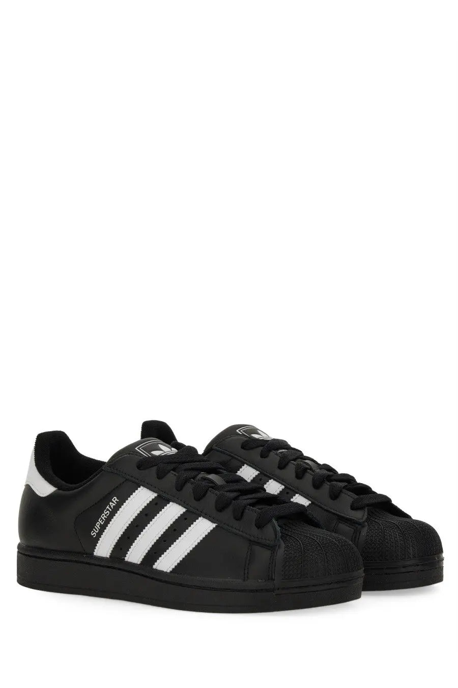 Black adidas unisex superstar sneaker featuring white three-stripe detailing and textured rubber toe cap