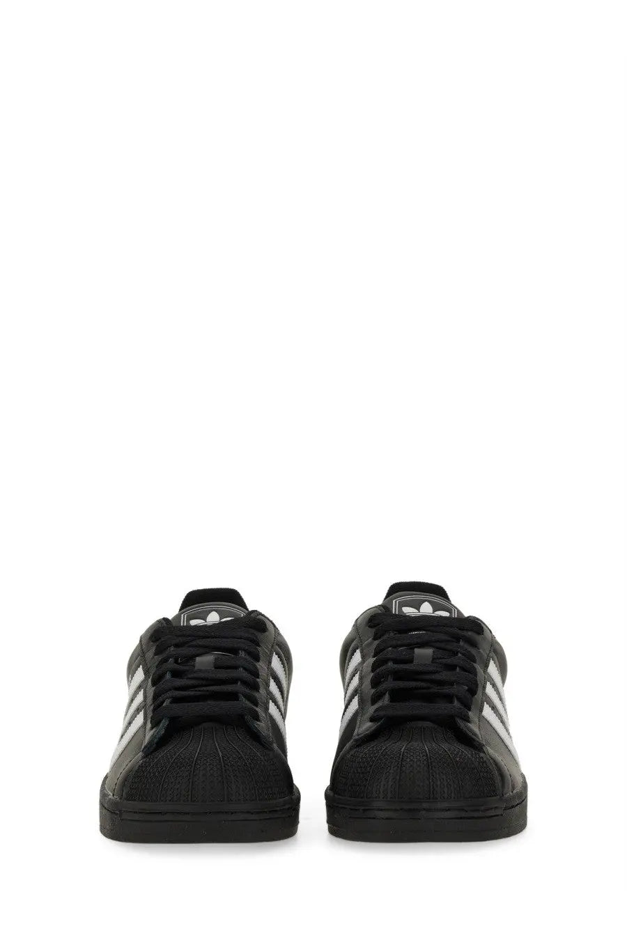 Black adidas unisex superstar sneaker with white three-stripe detailing and textured upper material