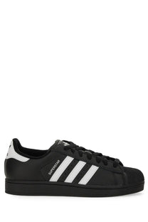 Black adidas unisex superstar sneaker with white three stripes and matching rubber toe cap