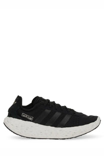 Adidas unisex zponge sneaker black running shoe with white textured sole and three black stripes on the side