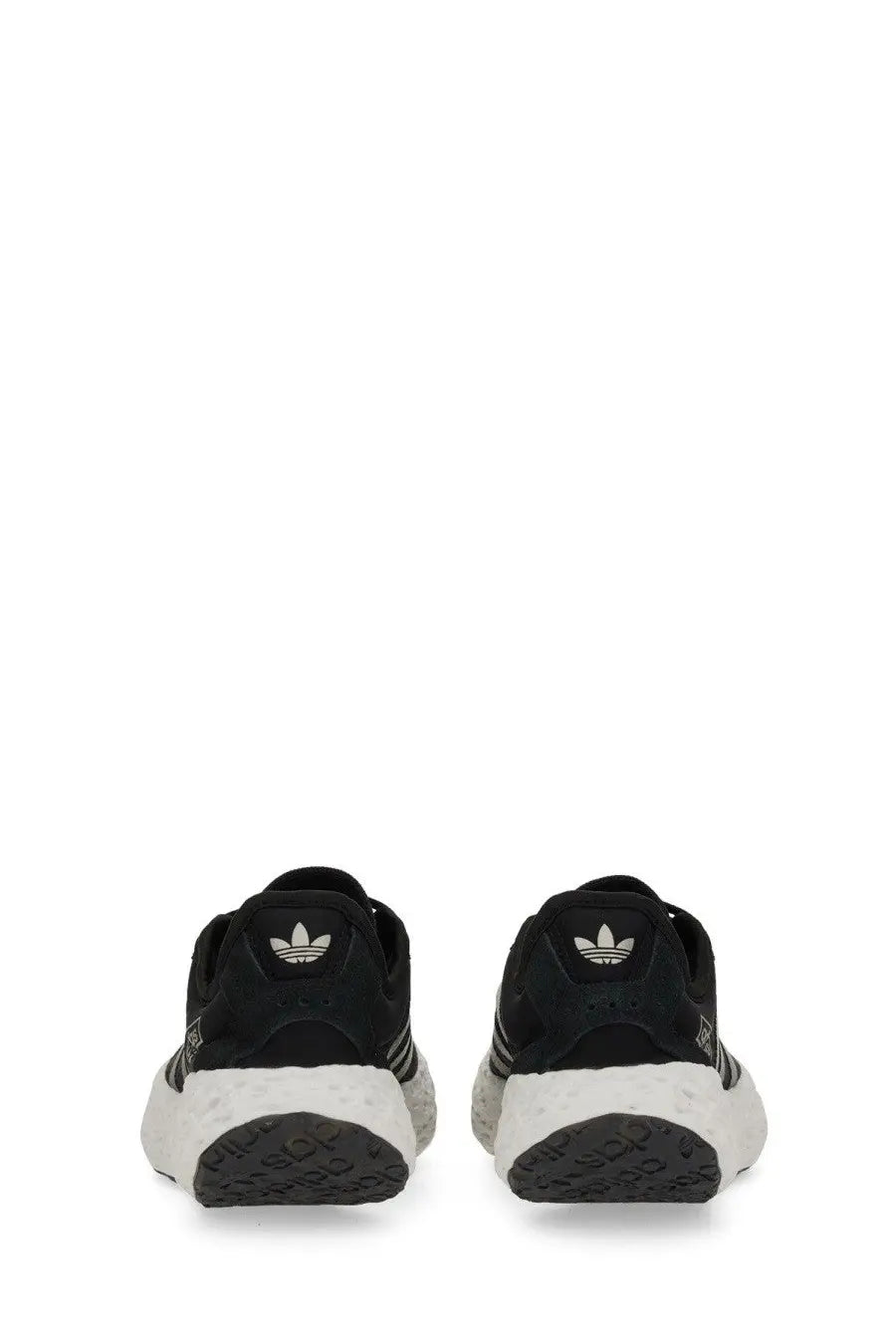Black adidas unisex zponge sneaker with white rubber sole and three stripes on the side