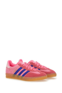 Adidas women’s gazelle indoor sneaker in pink suede with bold blue stripes and translucent gum sole