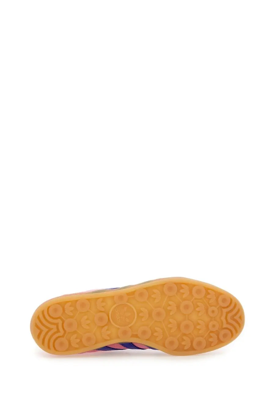 The sole of an adidas women’s gazelle indoor sneaker in blue with pink and purple stripes and gum rubber outsole
