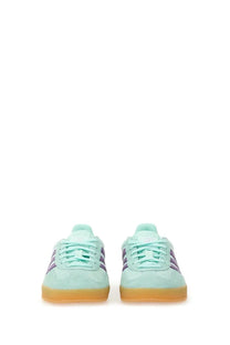 Adidas women’s gazelle indoor sneaker in mint green suede with purple stripes and a gum rubber sole